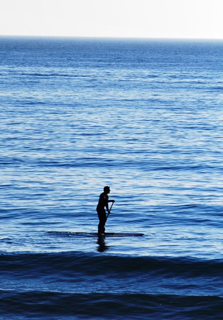 water, sea, horizon over water, full length, lifestyles, leisure activity, rear view, standing, tranquil scene, rippled, tranquility, scenics, men, nature, silhouette, beach, wave, beauty in nature