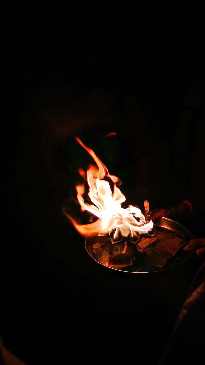 CLOSE-UP OF FIRE BURNING IN THE DARK