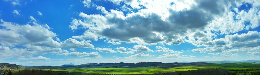 Scenic view of landscape against cloudy sky