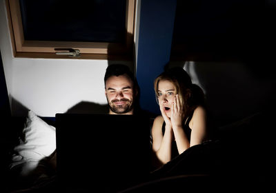 Couple using laptop at home