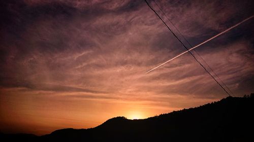 Silhouette landscape against sky at sunset