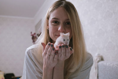 Happy girl with a small white syrian hamster. friendship between human and animal. 