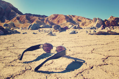 Sunglasses on the ground of death valley 