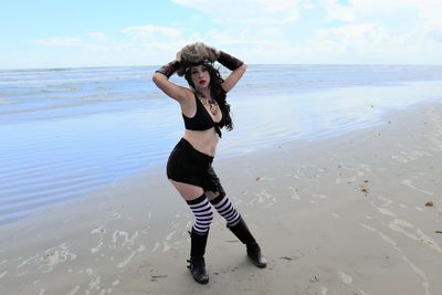 Full length of woman on beach against sky