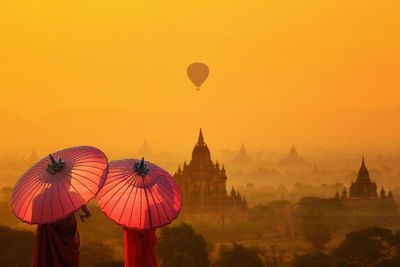 Hot air balloons against sky during sunset