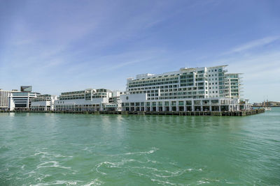 Buildings in city against blue sky