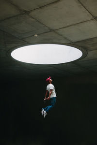 Side view of a man standing in tunnel