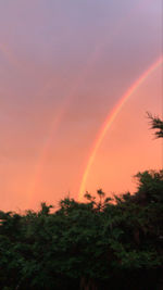 Scenic view of rainbow against sky during sunset