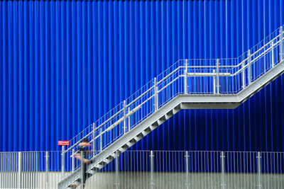 Metal staircase against blue wall