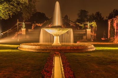 Illuminated fountain in park at night