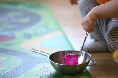 Child hands playing kitchen on kids playroom background 