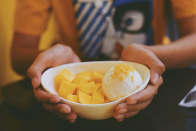 Midsection of woman holding fruit