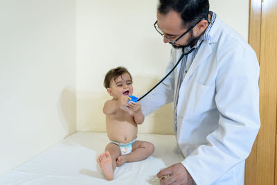 Doctor observing a one-year-old baby