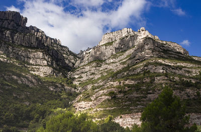 Low angle view of rocks against sky