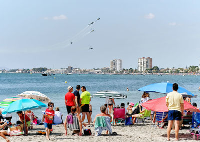 People on beach against sky