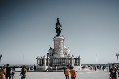 Statue with people in the background