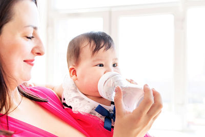 Portrait of mother and daughter drinking