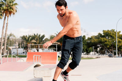 Boy doing skateboard trick on rail