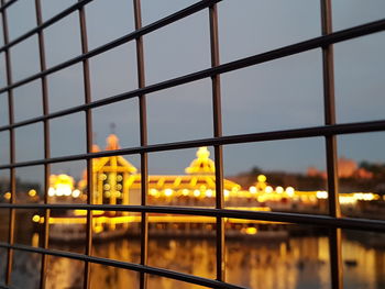 Close-up of illuminated bridge against sky at dusk