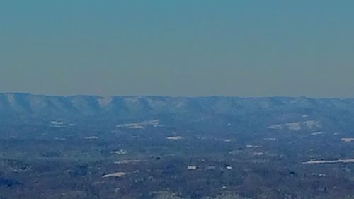 Scenic view of mountains against clear blue sky