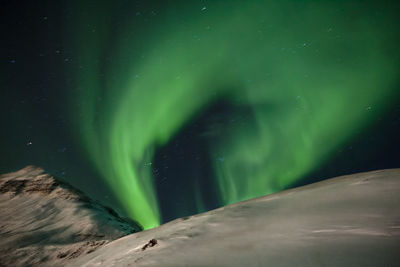 Scenic view of snowy landscape against sky at night