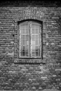 Low angle view of window on brick wall of building