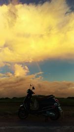 Car on landscape against sky during sunset