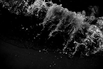 Close-up of splashing water against black background