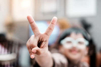 An autism boy displaying a peace gesture