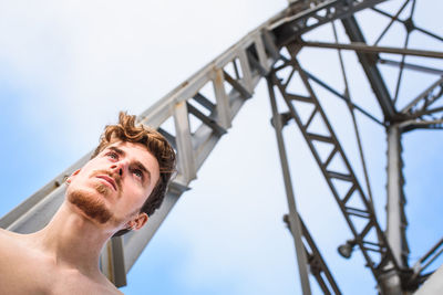 Low angel view of man standing against tower