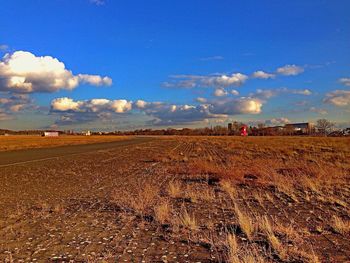 Scenic view of landscape against cloudy sky