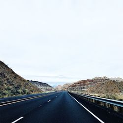 Empty road leading towards mountains