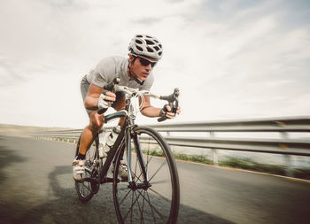 Man riding bicycle on road