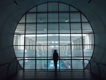 Silhouette woman standing modern building