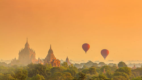 Hot air balloons against sky during sunset