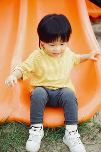 Portrait of boy sitting on sofa