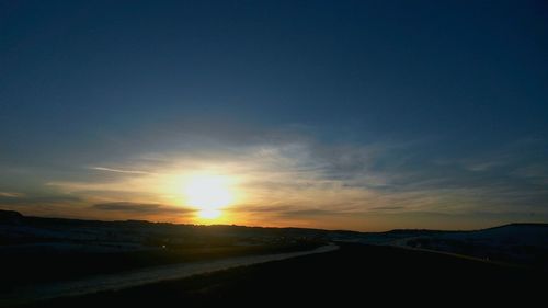 Scenic view of landscape against sky during sunset