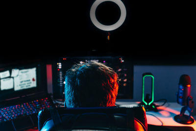 Rear view of gamer playing game