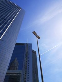 Low angle view of modern buildings against blue sky