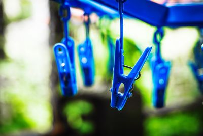 Close-up of clothespins hanging on rope