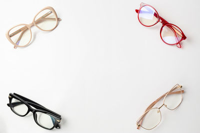 Close-up of eyeglasses on table against white background