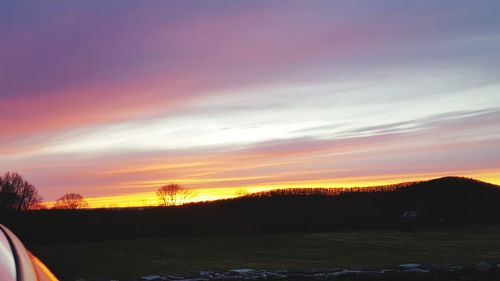 Scenic view of silhouette trees against sky at sunset