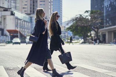 Women walking on street in city