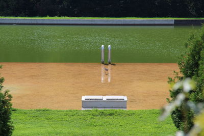 High angle view of field by lake