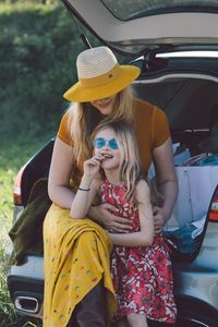 Rear view of women sitting in car