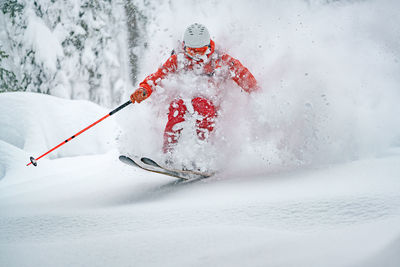 Adult man skiing in deep powder snow in the backcountry, werfenweng, austria