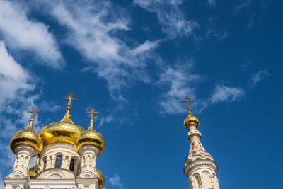 Low angle view of bell tower against blue sky