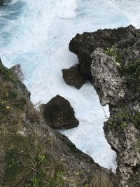 High angle view of rocks in sea