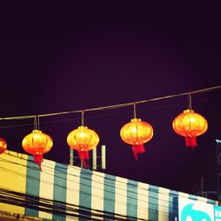 Low angle view of illuminated lanterns at night