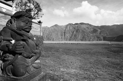 Statue on mountain against sky